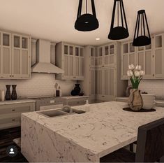 a large kitchen with marble counter tops and black pendant lights hanging from the ceiling above it