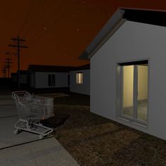 an empty shopping cart sitting in front of a small white house at night with the door open