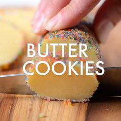 a person is cutting into a cake with sprinkles on it and the words butter cookies are in front of them