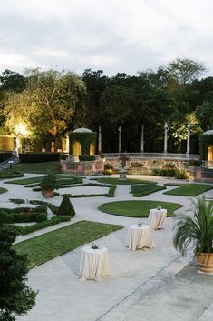 an outdoor dining area with tables and chairs set up for formal function in the evening