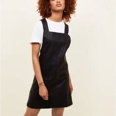 Brand New! Re-Work The Classic Pinafore Dress With A Leather-Look Finish. Combine With A White Tee And Ankle Boots To Complement. Uk 8 / 36 - Leather-Look Finish - Thick Straps - Square Neckline - Double Pocket Front - Mini Length - A-Line Fit - Ninoska Is 5'7.5"/171cm And Wears Uk 10/Eu 38/Us 6 Product Code: 590963601 Care Guide: Shell: 100% Polyurethane. Backing: 89% Polyester, 9% Cotton, 2% Viscose. Lining: 100% Polyester. Machine Washable. Leather Pinafore Dress, Leather Pinafore, Pinny Dress, New Look Dresses, Latest Dress For Women, Denim Jean Dress, Knit Skater Dress, Black Polka Dot Dress, Floral Skater Dress