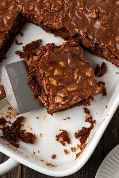 there is a cake with chocolate frosting on it and a knife in the middle