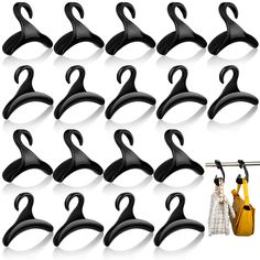 twelve pairs of black plastic hangers with hooks for coats and scarves hanging on clothes pins