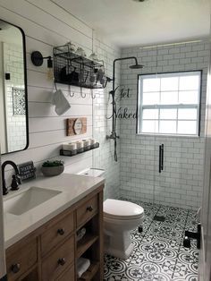 a bathroom with a toilet, sink and shower