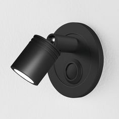 a black wall light on the side of a white wall