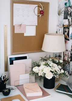 a desk with flowers, cards and other items on it