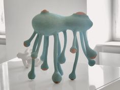 an octopus sculpture is on display in a white room