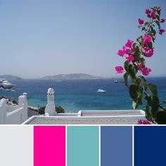 there is a color scheme with pink flowers on the roof and blue water in the background