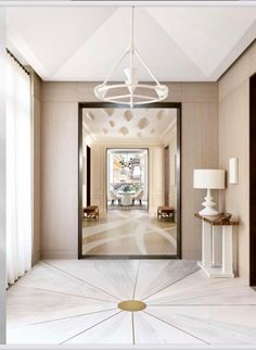 an open door leading to a hallway with a chandelier