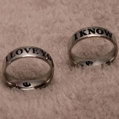 two wedding rings with the words i love you know on them