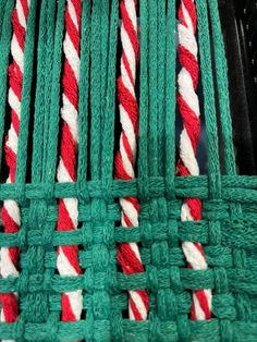 green rope with red and white stripes on it