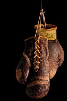 an old pair of boxing gloves hanging from a rope