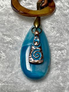 Simple but eye-catching lariat necklace with a brilliant 1 1/2" Blue Lace Agate pendant and a 1" ring of Mother of Pearl for closing, along with blue patina Bronze beads and a blue patina charm to add more color. All on 2mm distressed brown leather cord. To wear place open necklace around neck, then put pendant thru ring from the top. Adjust to your liking. No lead or nickel used. Please use the Last On, First Off approach. Stones discolor with lotions, perfumes, hairspray, sweat, chlorine, even Open Necklace, Pearl Leather, Blue Lace Agate, Agate Pendant, Lariat Necklace, Lace Agate, Boho Necklace, Blue Lace, Leather Cord