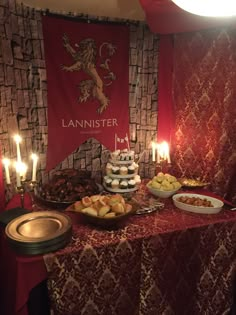 a table topped with lots of food and lit candles