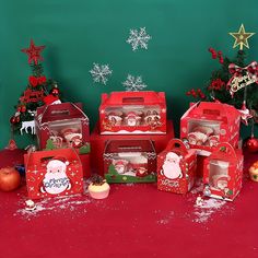 there are many boxes that have christmas decorations in them on the table next to each other