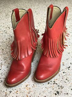 "1970's brick red fringed low height cowboy boots with a great patina by Frye. Estimated Size: US 5.5 Vintage size marked: 6 B Insole: 9\" Width: 3.25\" Heel height: 2.5\" Circa: 1970's Condition: Good vintage condition. Subtle wear, scuffs / marks. SOLD AS-IS. Follow us on Instagram for the latest----> http://instagram.com/closetcasevintage @closetcasevintage Please contact us about any questions you may have regarding condition before purchasing. Read the blog for updates, giveaways and sty Red Leather Boots For Ranch, Red Western Heeled Boots With Snip Toe, Red Round Toe Heeled Boots For Rodeo, Red Bohemian Boots For Fall, Red Western Heeled Boots With Round Toe, Red Leather Heeled Boots For Rodeo, Red Western Style Heeled Boots With Round Toe, Bohemian Red Leather Boots, Western Red Leather Moto Boots