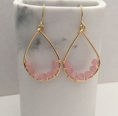 These pretty pink teardrop earrings were made by wrapping gold wire around beautiful 4mm glass cats eye beads. They dangle 3.5cm from gold ear wires. These light weight earrings would be perfect for prom, wedding, or any day. I will send these earrings in a gift box. Thanks for looking. Earrings Bridesmaid, Earrings Beaded, Eye Beads, Cats Eye, Trendy Earrings, Prom Wedding, Gold Wire, Rose Earrings, Light Weight Earrings