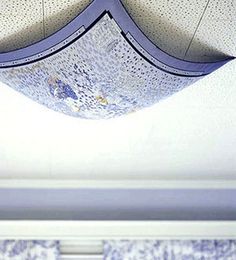 an upside down view of the ceiling in a room with blue and white wallpaper