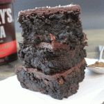 two pieces of chocolate cake sitting on top of a white plate