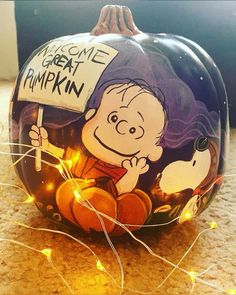 a glass pumpkin with a cartoon character painted on it