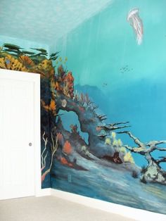 an underwater scene painted on the wall of a bedroom