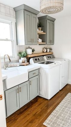 a kitchen with gray cabinets and white appliances