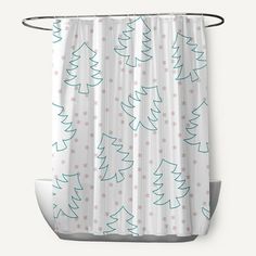 a shower curtain with white and blue christmas trees on the bottom, in front of a gray background