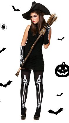 a woman dressed as a skeleton holding a broom and wearing a black hat with bats on it