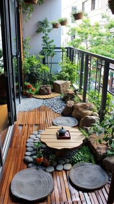 a wooden deck with plants and rocks on it