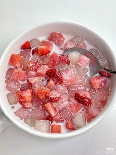 a white bowl filled with ice and strawberries