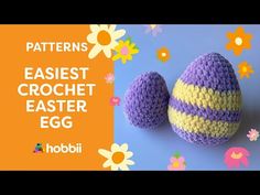 two crocheted easter eggs sitting next to each other on top of a blue surface