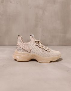 side of the steve madden diamond in the blush crystal rubber bubble sole sneaker on cement background - elle bleu shoes Gold Sneakers, Hair Ponytail Styles, Street Style Trends, Ponytail Styles, Synthetic Materials, Dark Tan, Trendy Sneakers, Style Trends, Elba