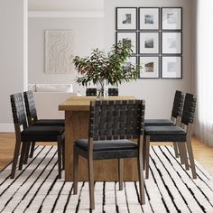 a dining room table with four chairs and a potted plant