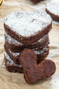 chocolate brownies stacked on top of each other with powdered sugar