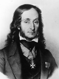 an old black and white photo of a man with long hair wearing a suit jacket