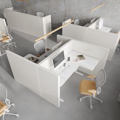 an office cubicle with desks and chairs