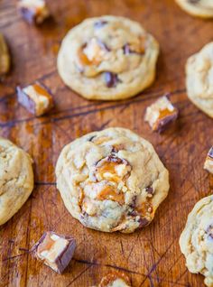 chocolate chip cookies with caramel chunks on a cutting board, ready to be eaten