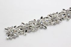 Beautiful ab crystal rhinestone trim perfect for all your bridal supplies need. Rhinestone have a beautiful brilliance and shine. Rhinestone trim is very flexible, can be cut any size or individual pieces. This rhinestone trim comes in 2 beautiful colors clear crystal, and ab crystal with silver metal setting. This listing is available to purchase by the yard (36''). Trim is about 1 1/4'' wide. Item ships in 2-3 business days. If you have any question please let us know we are here to help. Silver Crystal Sashes With Rhinestones, Silver Rhinestone Sashes For Party, Silver Rhinestone Party Sashes, Adjustable Bridal Belt With Rhinestones And Crystal, Adjustable Crystal Bridal Belt With Rhinestones, Adjustable Silver Crystal Bridal Belt, Silver Crystal Bridal Belt With Bling, Crystal Bridal Belt With Rhinestones, Headband Wedding