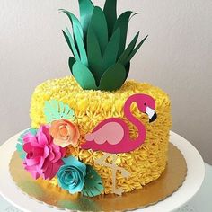 a cake decorated with flowers and a pink flamingo