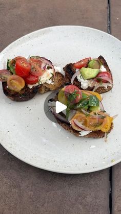 three pieces of bread with various toppings on it sitting on top of a white plate