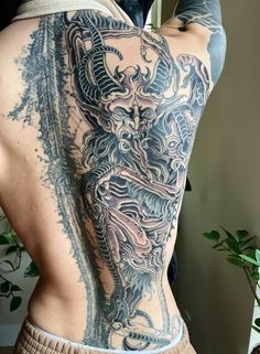 a man with a dragon tattoo on his back