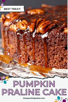 a close up of a cake on a plate with the words pumpkin praline cake