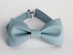 This trendy and stylish bow tie is great for so many occasions!Bow tie made of cotton fabric with a matching, adjustable neck strap. Style:• The Pre-Tied Bow Tie (with an adjustable neck strap)• The Clip-On Bow Tie (strapless, just a clip that you attach to the shirt collar)• Pocket square (handkerchief) All our bow ties can be made in the following sizes, just specify which size you need in a note at checkout: Sizes:Baby: 3.5" x 2"Kids: 4" x 2"Youth:  4.5" x 2.25Adult: 5" x 2.5"All our bow ties Elegant Light Blue Bow Tie For Formal Occasions, Elegant Blue Bow For Wedding, Elegant Light Blue Formal Bow Tie, Blue Bow With Bow Tie Back For Wedding, Blue Satin Bow Tie For Weddings, Blue Bow Tie With Bow Tie Back For Weddings, Blue Bow Tie For Wedding, Blue Wedding Bow Tie With Bow Tie Back, Blue Bow Tie With Bow Tie Back For Groom