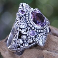 Faceted and polished amethyst crowns this elegant ring. Kadek Hendra works in sterling silver and amethysts totaling 3.4 carats. The handcrafted design reveals its Balinese origin with luscious flower and plant motifs. .925 Sterling silver Elegant Purple Amethyst Flower Ring, Stamped 925 Amethyst Ring Fine Jewelry, Amethyst Flower, Bohemian Rings, Purple Crystals, Amethyst Stone, Crystal Rings, Amethyst Ring, Ring Vintage