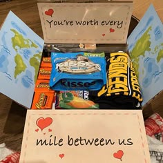 a box filled with candy and other items that say you're worth every mile between us