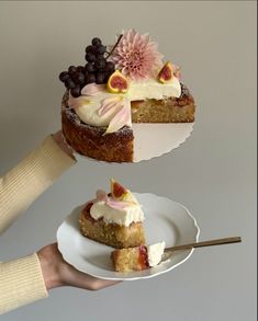 a person holding a piece of cake with fruit on it and another slice being lifted from the plate