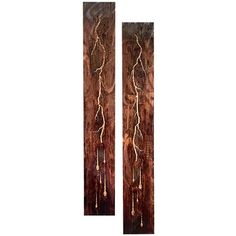 two wooden wall hangings with metal designs on them