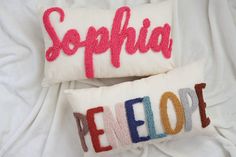 two decorative pillows with the word peepop on them