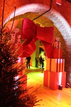 the entrance to an indoor event with red and white boxes on it's pillars