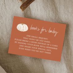 an orange card that says books for baby on it next to a pair of scissors